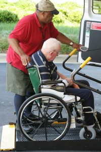 Elderly man being helped